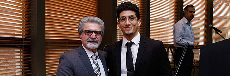 Smiling Chairperson Abdol-Hossein Esfahanian standing next to a Computer Science and Engineering Alumni at the Fall 2019 Grad Breakfast event