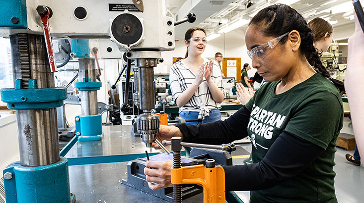 First-year student working on heavy machinery during a workshop