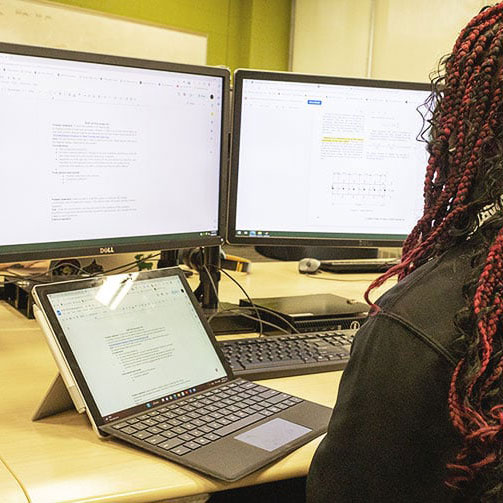Student engaged with the computer during an EGR 102 class session