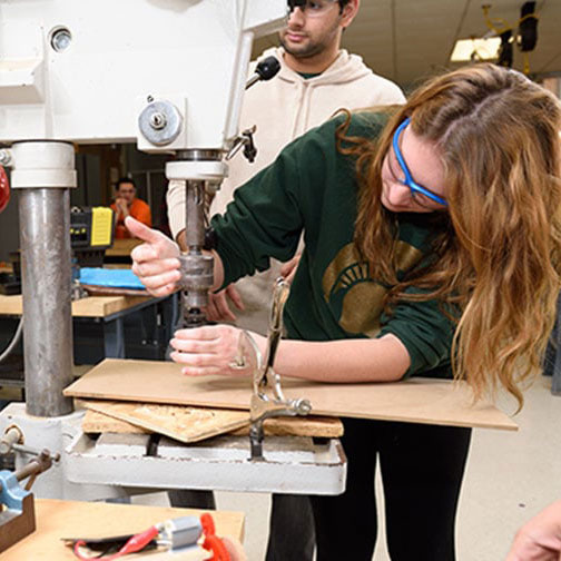 Student working with machinery