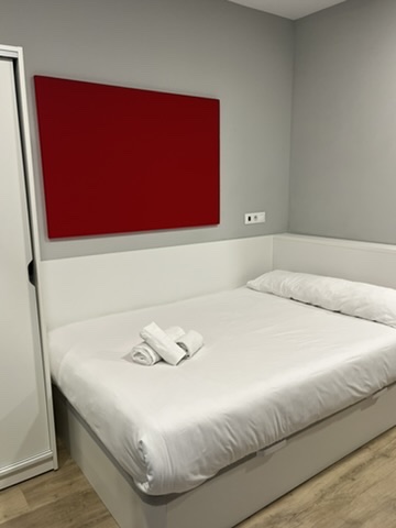 A bed with folded towels