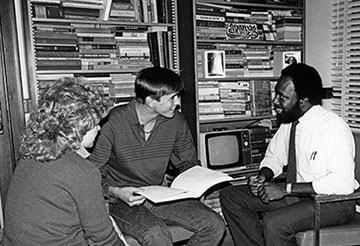 Old black and white photo of MSU students in a study room